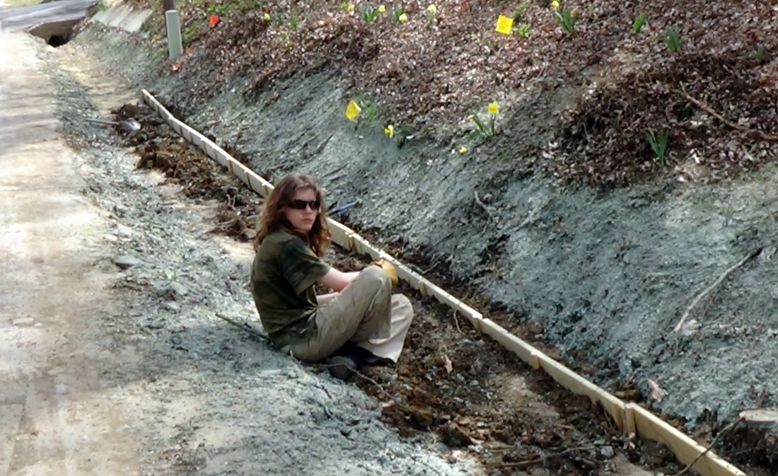 Refilling the dirt and tamping it down.