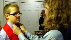 Nathan straightening Isaac's tie.