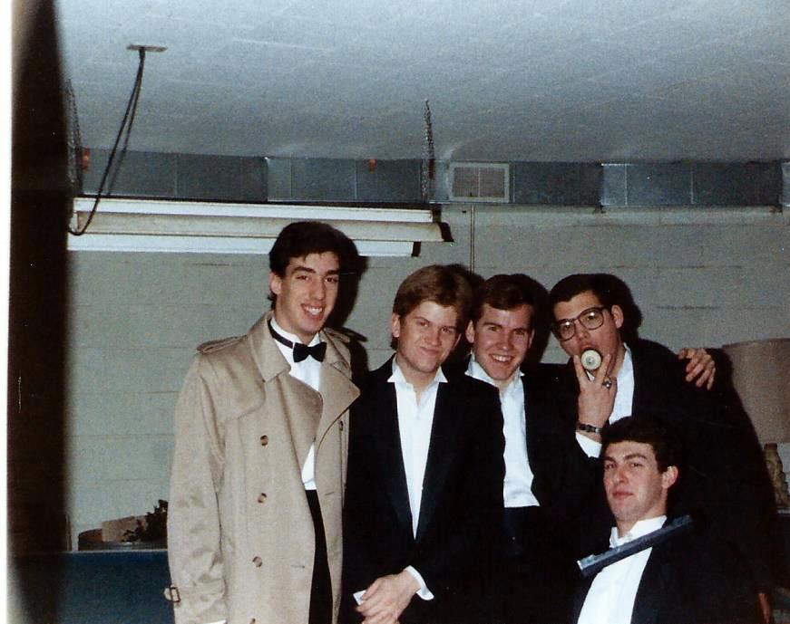 The guys who stayed at my house posing in the game room around the pool table. 